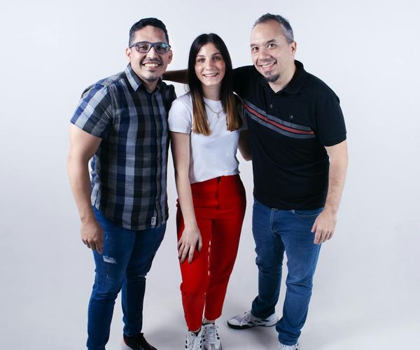 Diverse group of people smiling and looking relaxed in a bright studio.